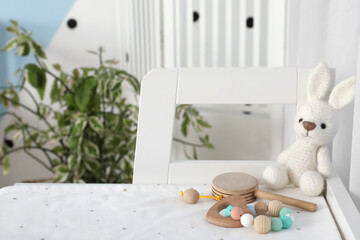 Toy rabbit, teether and rattle in baby room