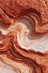 Abstract rock formation with swirling patterns in shades of red, orange, and white. Natural geological textures create a visually striking scene.