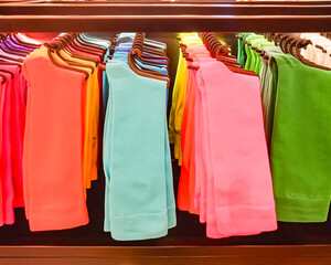 Some socks of different colors on hangers lined up for sale in a store