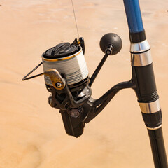 A fishing reel or spinning reel with a blurred background