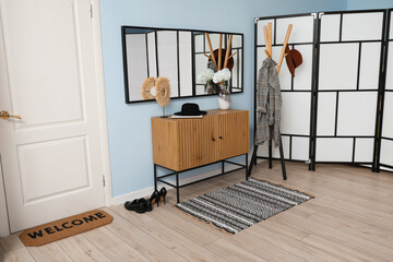 Stylish interior of modern hallway with hanger and mirror