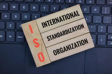 ISO Concept on Wooden Blocks Above Keyboard Highlighting the Theme of International Standardization
