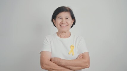 Elderly with Yellow Ribbon for concept of yellow September, Suicide prevention day, Childhood, July Sarcoma, bone and bladder cancer Awareness month, support survivor. Healthcare and World Cancer day