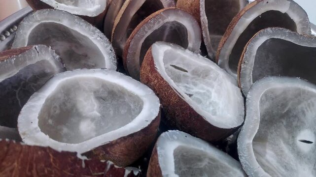 A closeup video of pile of dry cut coconut pieces for sale at indian market