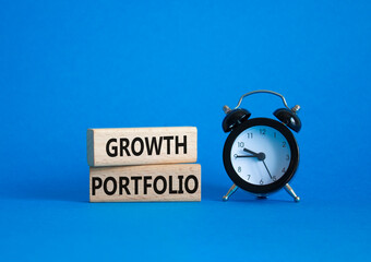 Growth Portfolio symbol. Concept word Growth Portfolio on wooden blocks. Beautiful blue background with alarm clock. Business and Growth Portfolio concept. Copy space