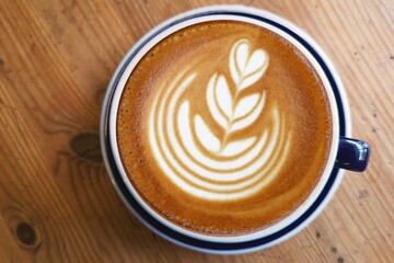  a cup of latte art coffee on wooden background                                                                                                                                                         