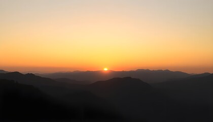 Obraz premium Sunset behind mountain ridges during summer evening with glowing horizon and pastel gradient sky.