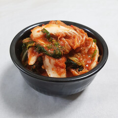 Fresh and Spicy Geotjeori Kimchi in a Black Bowl