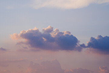 Colorful Cumulus Cloud Illuminated by Sunset in a Pastel Evening Sky