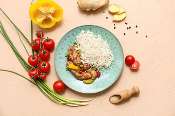 Tasty sweet and sour chicken with rice in plate and vegetables on beige background