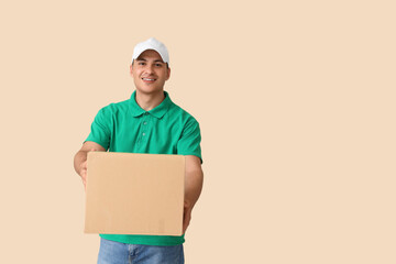 Delivery man with parcel box on beige background