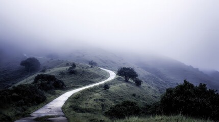 Winding road through a misty mountain landscape.