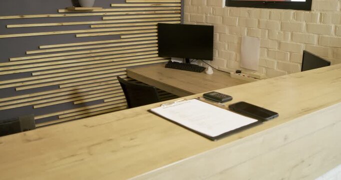 At clip start camera is panning right and zooming to highlight gym registration form on clipboard