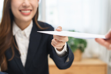 Good job Asian manager businesswoman giving financial reward in an envelope, business letter extra salary to company employee, woman worker office hand received premium bonus, getting cheque from boss