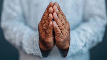 Fototapeta premium Close up of hands in prayer wearing a traditional Islamic ring The image conveys a sense of spiritual devotion faith and connection to higher powers through the reverent gesture of prayer
