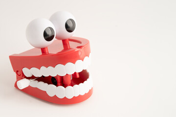 Funny red teeth with eye toy denture model for dental health care.