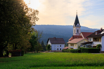 Parish church of the Sacred Heart of Jesus in village Ludwigsthal (Lindberg) with Bavarian Forest National Park mountain panorama, Germany