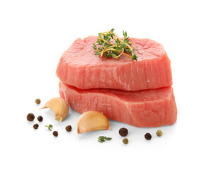 Fresh raw steaks with thyme, garlic and peppercorns on white background