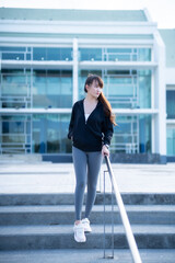 Portrait of beautiful asian Young woman in Black robe sportswear working out outside. training on...