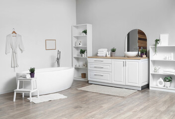 Interior of modern white bathroom with pots of lavender flowers