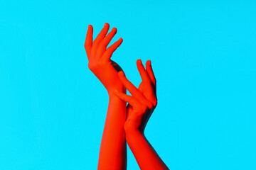 Toned female hands on blue background