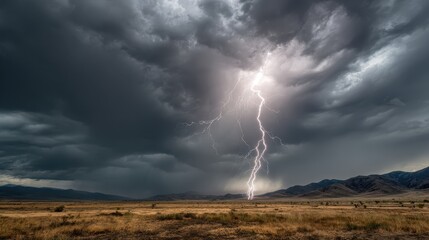 Lightning strikes over a plain, with dramatic clouds. Weather alert background