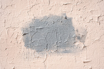 Center gray paint patch with visible cracks on wall texture