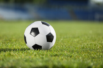 Soccer ball on green stadium grass, closeup