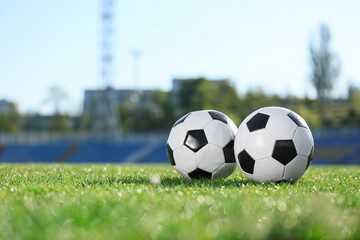 Soccer balls on green stadium grass