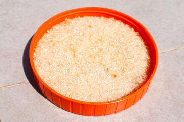 Top view of sugar under the sun on the floor.