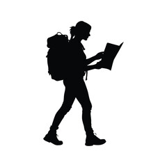 Silhouette of a woman hiker with backpack reading a map while walking