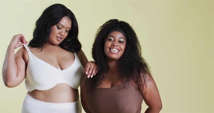 Diverse female models in studio responding to loose strap tugging bra ensuring fit while smiling
