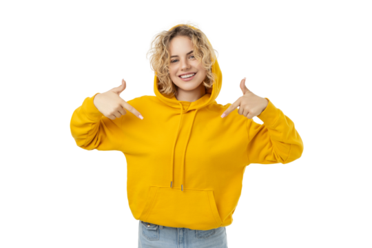 Happy woman in yellow hoodie points at herself, isolated on white, PNG