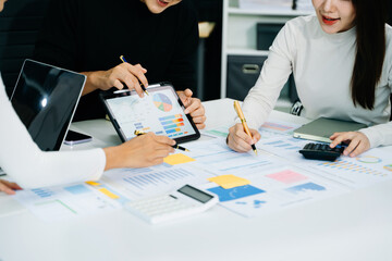 Businessman and team analyzing financial statement Finance task. with smart phone and laptop and...