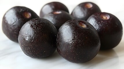Close-up view of several dark purple berries.