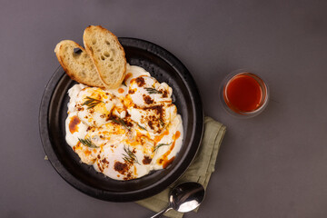 Cilbir or Turkish Eggs is Poached Eggs With Creamy Yogurt and Butter Sauce. 