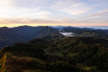 Landscape of Morning Mist with Mountain Layer. mountain ridge and clouds in rural jungle bush forest