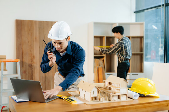 Architects and engineers collaborate on a building model, designing, planning, and measuring with teamwork, - Powered by Adobe