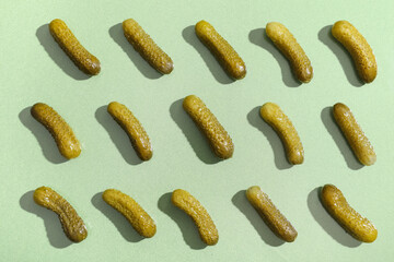 Texture of tasty pickled cucumbers on green background