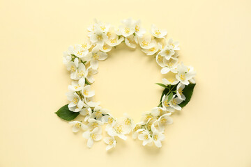 Frame made of beautiful jasmine flowers on yellow background