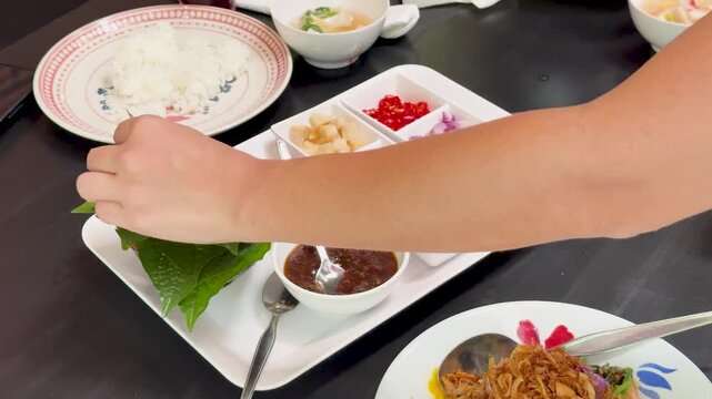Preparing Miang Kham Savory Leaf Wraps at Dining Table