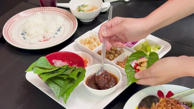 Preparing Miang Kham Savory Leaf Wraps at Dining Table
