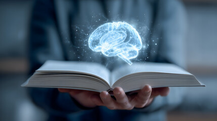 Person holding an open book with a holographic brain floating above it, representing AI.