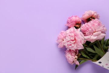 Party hat with beautiful pink peony flowers on lilac background