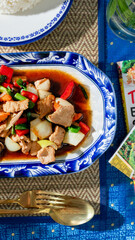 Vibrant stir-fry in blue porcelain dish, culinary symphony for Songkran and Lunar New Year,...