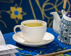 White porcelain teacup brimming with verdant jasmine brew, echoing Zen tranquility on World Tea...