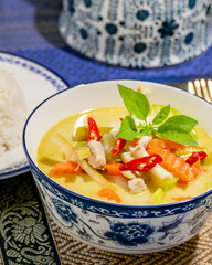 Aromatic Thai curry in ornate blue ceramic bowl evokes Songkran festival feasts and vibrant rich culinary tapestry