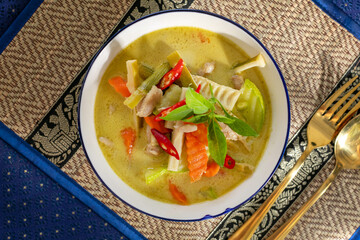 Green curry with vibrant veggies and fiery chilies dances in harmony, Thai New Year delight, tantalizing spice-laden symphony
