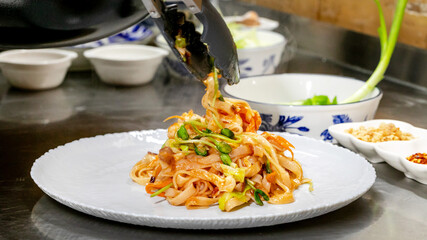 Zesty vegetable noodle medley twirls joyously on porcelain, evoking Lunar New Year feasts and World...