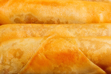 Golden-hued crepes glisten invitingly, evoking Shrovetide indulgence, Pancake Day whimsy, and sunrise-soaked breakfast nostalgia